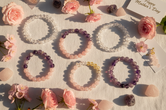 Crystal bracelets gift set for Mother's Day featuring rose quartz, amethyst and citrine on white linen with pink flowers