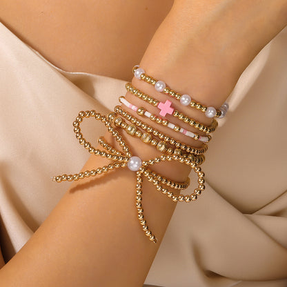 European and American cross-border hand jewelry personalized bow beaded cross multi-layer bracelet INS style imitation pearl bracelet women